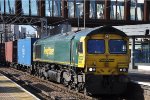 A Class 66 leads an outbound container train through the station